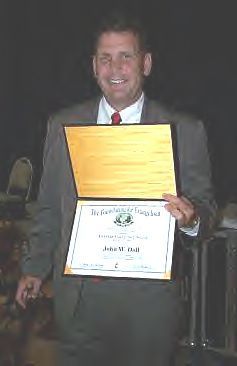 Pastor John Accepting Denman Award
